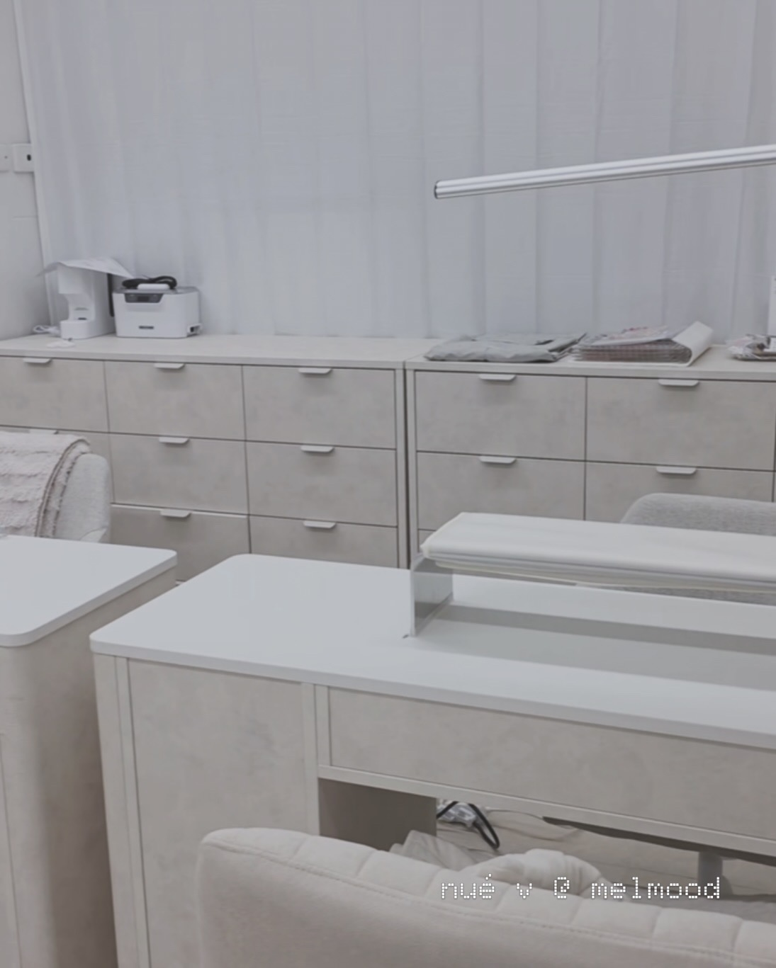 The nué v studio, with ivory manicure desks, soft neutral chairs and light curtains
